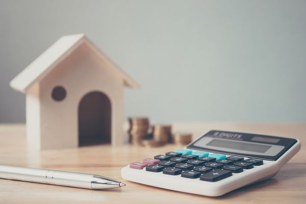 Image of tiny house and calculator. Can I Save Money With a Heat Pump?