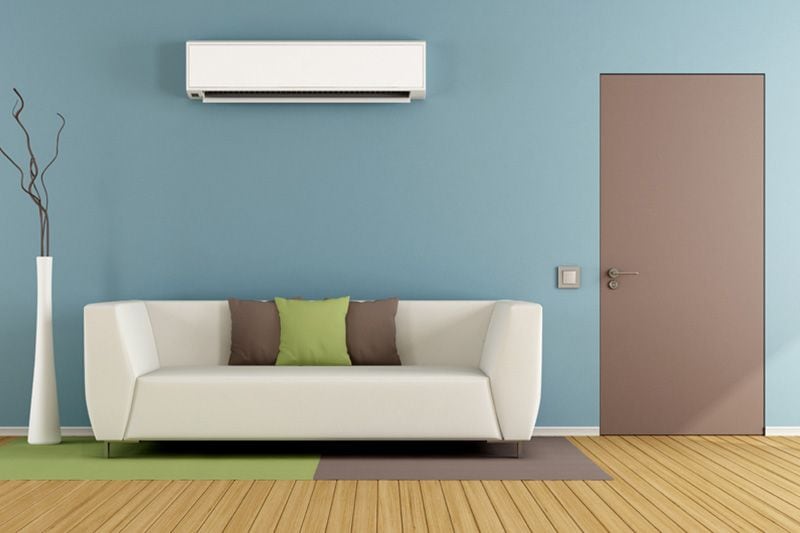 Image of a ductless system above a couch. Planning to Remodel? Go Ductless!